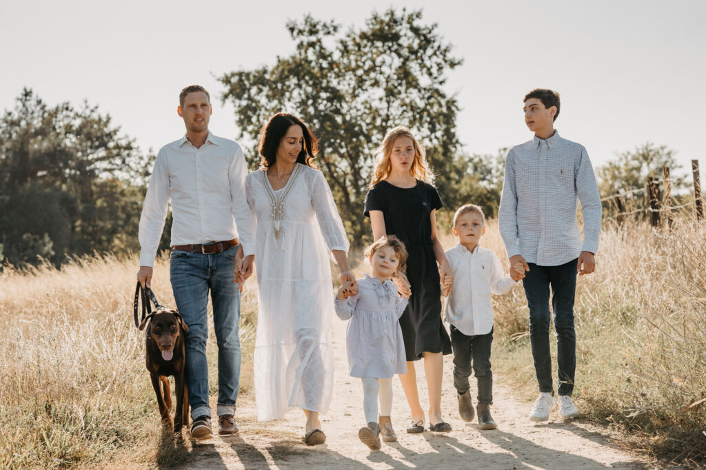 Große Familie mit Kindern und Hund bei einem Spaziergang